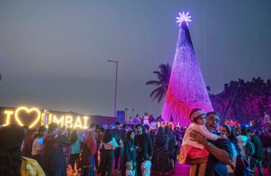 MUMBAI, INDIA - DECEMBER 25, 2024: Mumbaikars enjoy evening Christmas decorations and instilments during the Christmas at Cartar Road, Bandra, on December 25, 2024 in Mumbai, India. (Photo by Satish Bate/Hindustan Times) clipart