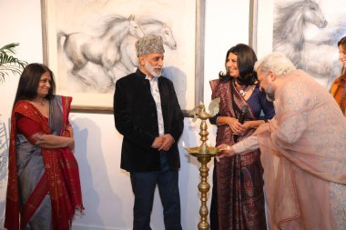 NEW DELHI INDIA: NOVEMBER 28, 2024 - Uma Nair and artist Sujata Dere with Hotelier Aman Nath during the opening of artist Sujata Deres exhibition Earth Song at Visual Arts Gallery in India Habitat Centre.  clipart