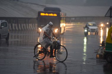 GURUGRAM INDIA DECEMBER 27 2024 People going to their workplace amid rain on a winter morning at Rajiv chowk near district court on December 27 2024 in Gurugram India Delhi and nearby areas received moderate to heavy rain on Friday leading to a drop  clipart