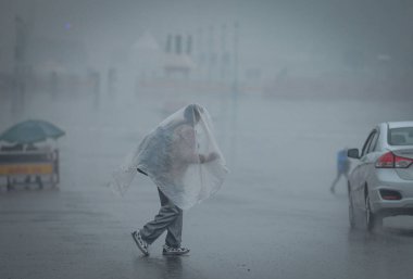 NEW DELHI INDIA DECEMBER 27 2024 Commuters out in cold and rainy weather morning at Kartavya Path near India Gate on December 27 2024 in New Delhi India Delhi and nearby areas received moderate to heavy rain on Friday leading to a drop in temperature clipart