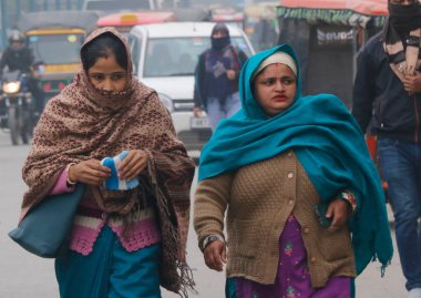 GURUGRAM INDIA DECEMBER 29 2024 People walks through a street on a cold winter morning at MDI Chowk on December 29 2024 in Gurugram India North India is reeling under cold weather with temperatures plummeting across several states As per IMD the mini clipart