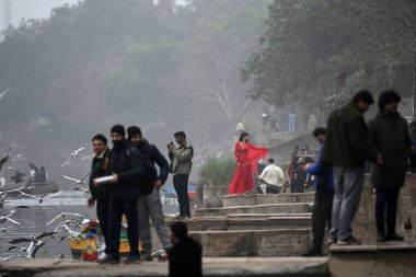 NEW DELHI INDIA DECEMBER 29 2024 Yamuna Ghat at Kashmiri Gate emerges as the most iconic picnic spot during sunrise on weekend as people in large numbers gathered to feed seagull birds on December 29 2024 in New Delhi India North India is reeling und clipart