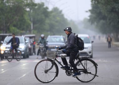 NOIDA, INDIA: 30 ARALIK 2024 - 25. Bölge 'de insanlar sıcak kıyafetler giyerek dışarı çıktılar.. 