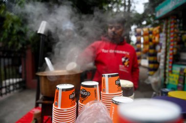 NOIDA INDIA DECEMBER 30 2024 A tea vendor making tea on the roadside in a cold morning Cold has increased in Delhi NCR mercury has gone down further morning temperature was 8C on December 30 2024 in Noida India  clipart