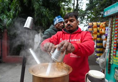 NOIDA INDIA DECEMBER 30 2024 A tea vendor making tea on the roadside in a cold morning Cold has increased in Delhi NCR mercury has gone down further morning temperature was 8C on December 30 2024 in Noida India  clipart