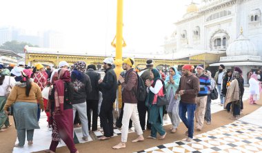 NEW DELHI, INDIA - JANUARY 1, 2025: Devotees visit Bangla Sahib gurudwara to offer prayers on the first day of New Year 2025, on January 1, 2024 in New Delhi, India. (Photo by Sonu Mehta/Hindustan Times) clipart