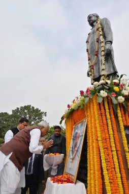 PATNA, INDIA - DECEMBER 31: Bihar Chief Minister Nitish Kumar pay tribute to statue of Navin Kishore Prasad Sinha on his death anniversary at Rajvanshi Nagar on December 31, 2024 in Patna, India. clipart