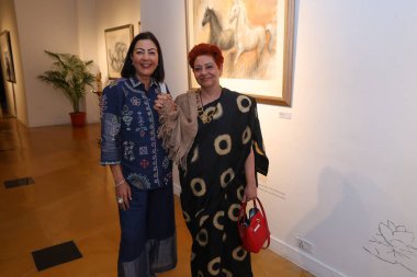 NEW DELHI, INDIA - NOVEMBER 28, 2024: Neelam Pratap Rudy and Punam Kalra (R) during the opening of artist Sujata Deres exhibition Earth Song at Visual Arts Gallery in India Habitat Centre, on November 28, 2024 in New Delhi, India. clipart