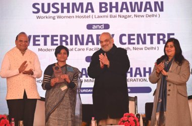 NEW DELHI INDIA JANUARY 4 2025 Union Home Minister & Minister of Cooperation Amit Shah along with LG Delhi VK Saxena and MP Bansuri Swaraj and others heading over room keys to a working women after inaugurating Sushma Swaraj Bhawan Working Women Host clipart