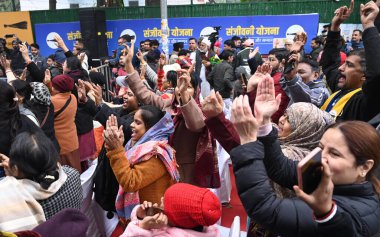 AAP workers dancing during Aam Aadmi Party AAP chief Arvind Kejriwal launch of the partys campaign song for the upcoming Delhi Assembly elections on January 7 2025 in New Delhi India clipart