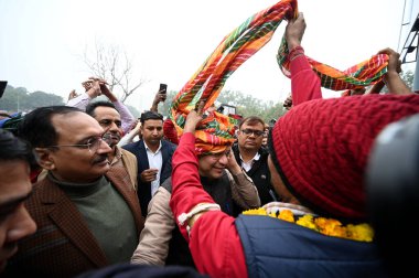 NEW DELHI INDIA JANUARY 7 2025 Union Minister of Railways Ashwini Vaishnaw along with Delhi BJP President Virendra Sachdeva interact railway coolie porter and auto drivers at New Delhi Railway Station ahead of Delhi assembly election on January 7 202 clipart