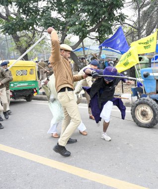 CHANDIGARH, INDIA, JANUARY 7 ,2025 Police personnel detain the Gurcharan singh father of Jagatr singh hawara and others during the Kaumi Insaf Morcha protest at the Sector 43 52 dividing road on January 7 2025 in Chandigarh India Since February 2023  clipart