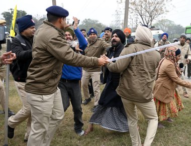 CHANDIGARH, INDIA, JANUARY 7 ,2025 Police personnel detain the Gurcharan singh father of Jagatr singh hawara and others during the Kaumi Insaf Morcha protest at the Sector 43 52 dividing road on January 7 2025 in Chandigarh India Since February 2023  clipart