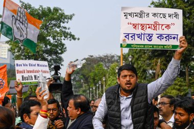 KOLKATA INDIA JANUARY 13 2025 Congress activists hold a saline water bottle during protest rally from Karunamoyee to Swasthya Bhavan against death of a woman after administered expired saline water produced by Paschim Banga Pharmaceuticals Ltd and de clipart