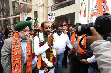 NEW DELHI INDIA JANUARY 15 2025 Ramesh Bidhuri the BJP candidate from the Kalka Ji constituency held a public meeting before filing his nomination also seen with Union Minister Hardeep Singh Puri at EWS Flats Kalka Ji on January 15 2025 in New Delhi  clipart