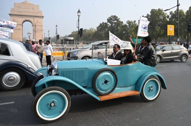 NEW DELHI INDIA FEBRUARY 2 2025 Vintage vehicles drive by District Election Office to promote Vintage Drive for Voter Awareness ahead of Delhi assembly election India Gate circle on February 2 2025 in New Delhi India The rally was flagged off from th clipart