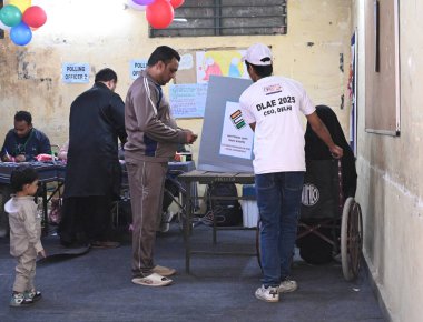 NEW DELHI INDIA FEBRUARY 5 2025 People cast their vote for Delhi Assembly election at SKV School Asaf Ali Road on February 5 2025 in New Delhi India  clipart