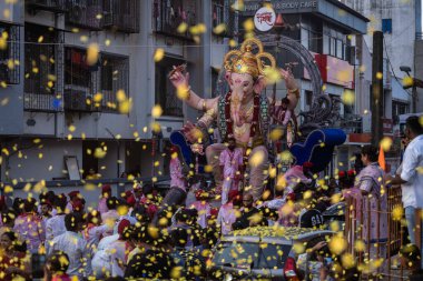  Devotees take the Maghi Ganpati of Charkops Peshwai Mandal for immersion in sea on February 11 2025 in Mumbai India clipart