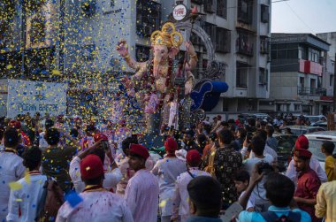  Devotees take the Maghi Ganpati of Charkops Peshwai Mandal for immersion in sea on February 11 2025 in Mumbai India clipart