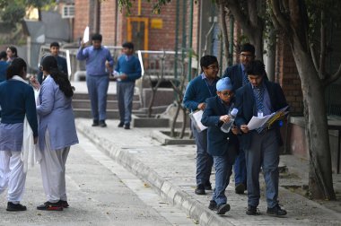 NEW DELHI, INDIA - FEBRUARY 15,2025: Students coming out from the exam centre after appearing the CBSE class 10th exam, at Bhartiya Vidya bhawan, KG Marg, on February 15, 2025 in New Delhi, India.  clipart