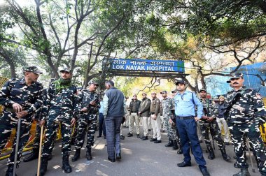 NEW DELHI, INDIA - FEBRUARY 16: Security personnel stand guard outside the Lok Nayak Hospital, where injured victims of the New Delhi Railway Station stampede are admitted, on February 16, 2025 in New Delhi, India.  clipart