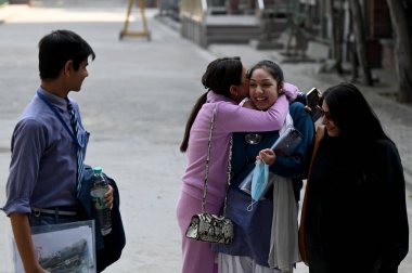 NEW DELHI, INDIA - FEBRUARY 15,2025: Students coming out from the exam centre after appearing the CBSE class 10th exam, at Bhartiya Vidya bhawan, KG Marg, on February 15, 2025 in New Delhi, India.  clipart