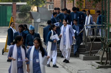 NEW DELHI, INDIA - FEBRUARY 15,2025: Students coming out from the exam centre after appearing the CBSE class 10th exam, at Bhartiya Vidya bhawan, KG Marg, on February 15, 2025 in New Delhi, India.  clipart