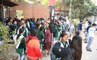 NEW DELHI, INDIA - FEBRUARY 17, 2025: Students of 12th class standing outside the examination center for Physical education CBSC Board Exam a government School at Jheel Chowk in East Delhi, on February 17, 2025 in New Delhi, India. clipart