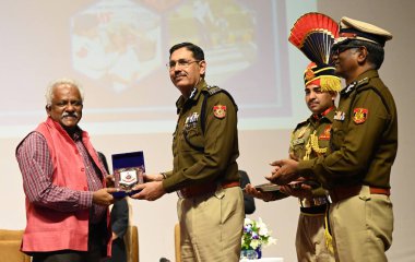 NEW DELHI INDIA FEBRUARY 21 2025 Commissioner of the Delhi Police Sanjay Arora present a Memento Velmurugan during the Seminar on Road Safety and Efficient Traffic Management by Delhi Traffic Police at Adarsh Auditorium PHQ Jai Singh Road on February clipart