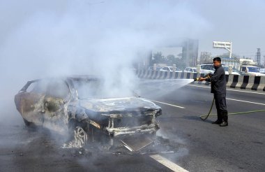 GHAZIABAD, INDIA - 26 Mart 2025 'te Delhi Meerut Otoyolu' nda, bir arabanın lastikleri patladıktan sonra hasar gören bir Baleno arabası aniden alev aldı ve 26 Mart 2025 'te Hindistan' ın Gaziabad kentinde tüm araba alev aldı.. 