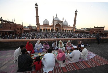 YENİ DELHI, INDIA - 30 Mart 2025 'te Hindistan' ın Yeni Delhi kentinde Müslümanlar Ramazan Ramazan Ramazan ayının son gününde Aydınlanmış Jama Mescidi önünde oruç tutuyorlar.. 