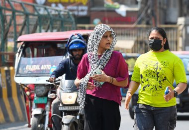 NOIDA, INDIA - 6 Nisan 2025: Delhi-NCR 'de sıcaklık artarken, Hindistan' ın Noida kentinde 6 Nisan 2025 tarihinde, 38. bölgedeki sıcaklıktan kaçmak için banliyö sakinleri başlarını örtmektedir. (Fotoğraf: Sunil Ghosh / Hindustan Times)