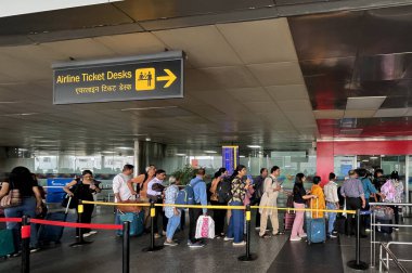 NEW DELHI, INDIA - 12 Nisan 2025 'te Hindistan' ın Yeni Delhi kentinde dünkü toz fırtınasından sonra birkaç uçuşun ertelenmesiyle IGI 'nin T2' sinde kuyrukta bekleyen yolcular görülüyor.. 