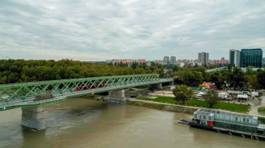 Aerial Drone Photo of Red Electric Tram Traveling on Bratislava, Slovakia's Historic Stary most clipart