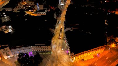 Bratislava Eski Kasabası, Slovakya 'nın hava aracı gece fotoğrafı. Sokakta dolaşan bir tramvayı gösteriyor..