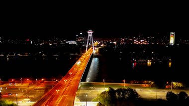 Aerial drone night photo of Most SNP in Bratislava Old Town, Slovakia clipart