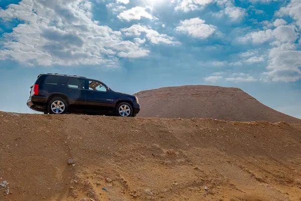 Siyah bir GMC Yukon Otobanda Arkaplanda Çöl Arazisi Var