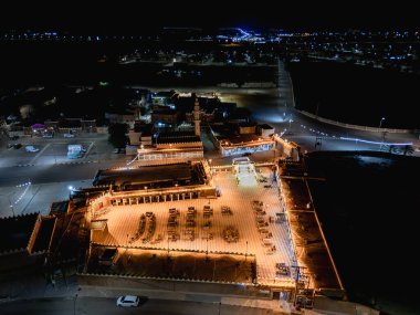 Aerial night drone view of the illuminated Hlewa Heritage Market. The market serves as a hub for cultural exchange and community gatherings.