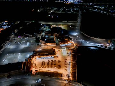 Aerial night drone view of the illuminated Hlewa Heritage Market. The market serves as a hub for cultural exchange and community gatherings.