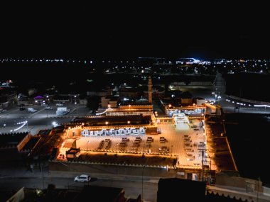 Aerial night drone view of the illuminated Hlewa Heritage Market. The market serves as a hub for cultural exchange and community gatherings.
