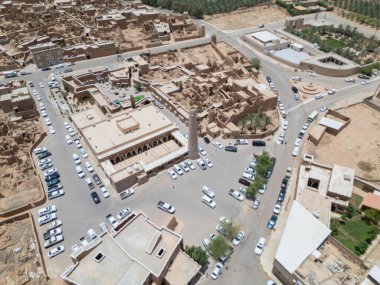 Aerial drone image of Shaqra Heritage Village showcasing preserved Najdi mudbrick homes, winding alleyways, and fortified walls, capturing the essence of Saudi heritage.