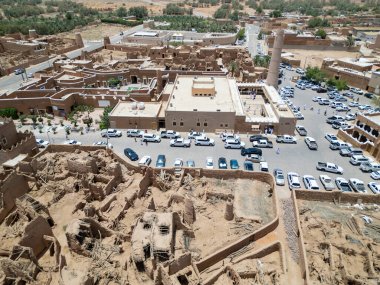 Aerial drone image of Shaqra Heritage Village showcasing preserved Najdi mudbrick homes, winding alleyways, and fortified walls, capturing the essence of Saudi heritage.