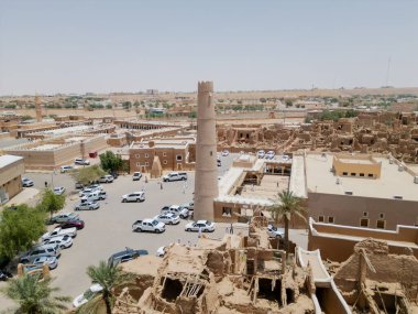 Aerial drone image of Shaqra Heritage Village showcasing preserved Najdi mudbrick homes, winding alleyways, and fortified walls, capturing the essence of Saudi heritage.