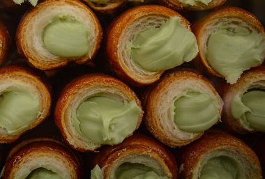 Italian sweet rolls with pistachio cream in Milan. Sicilian canolli rolls, uisine in Italy. Coffee and sweets clipart