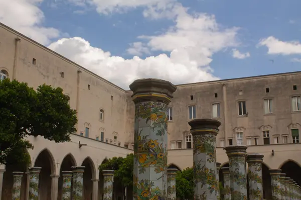 stock image Beautiful tiled pillars with fine decorations on maiolics plated at the cloister garden of Santa Chiara Monastery, Naples, Italy. Vacation in Italy