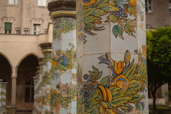 stock image Beautiful tiled pillars with fine decorations on maiolics plated at the cloister garden of Santa Chiara Monastery, Naples, Italy. Vacation in Italy