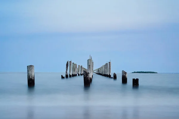 Stock image long exposure sea and wooden pillars