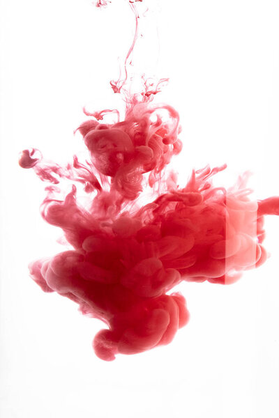 Red color flowing in smoke forms, smooth abstract moving by acrylic paint