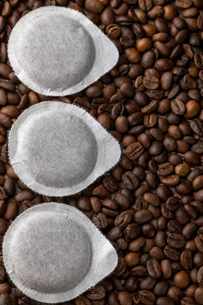 stock image Paper pods for coffee machine on coffee beans background
