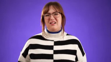 Öksürük ve boğaz ağrısı olan 20 'li yaşlardaki genç bir kadının portresi stüdyoda mor arka planda, fotokopi aletiyle izole edilmiş.